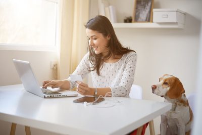 lady making an online payment being scam aware of online fraud