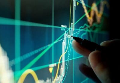 A stock trader checking stocks, pensions and investments