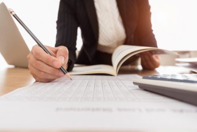 Accountant looking at a clients pension figures, considering tax implications