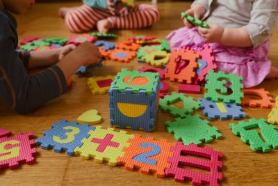 Kids playing with number puzzle, numbers worth knowing in 2020-21